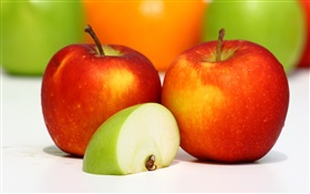 Dos manzanas rojas, rodaja de manzana verde, fruta sabrosa