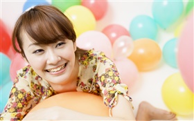niña feliz de Asia, globos de colores